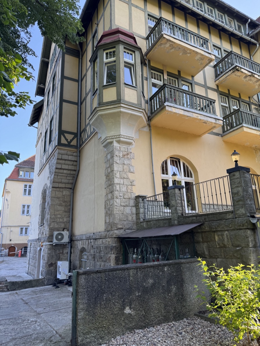 The same facade in Kudowa-Zdrój with an outdoor AC unit bolted to the wall